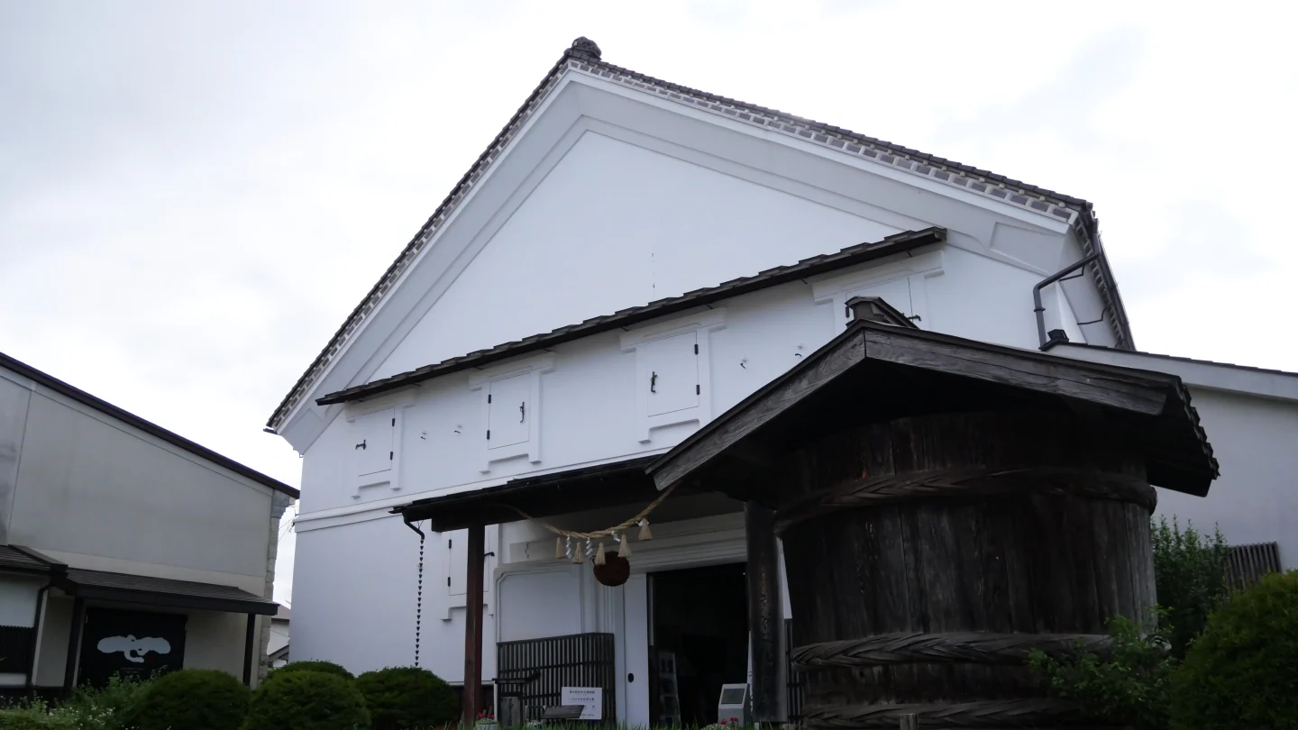 白壁の資料館と木造の建物が並ぶ世嬉の一酒造の敷地